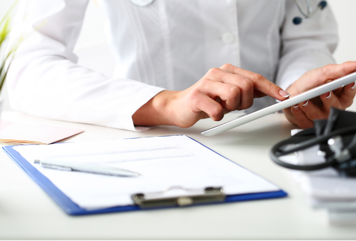 Healthcare professional looking at documents on their desk